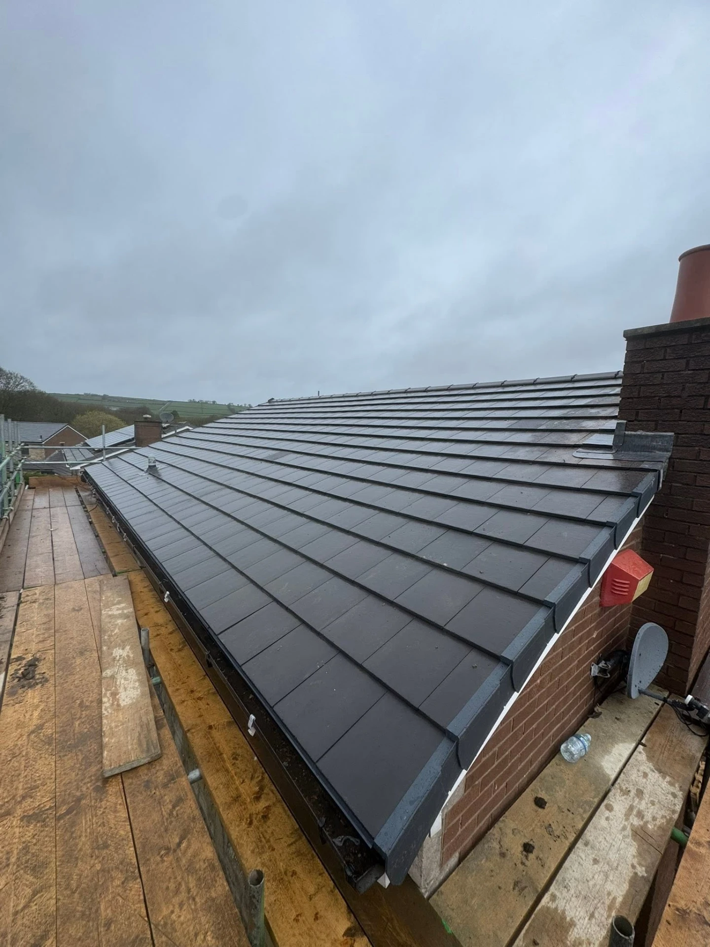 Completed grey tile re-roof after extensive repairs