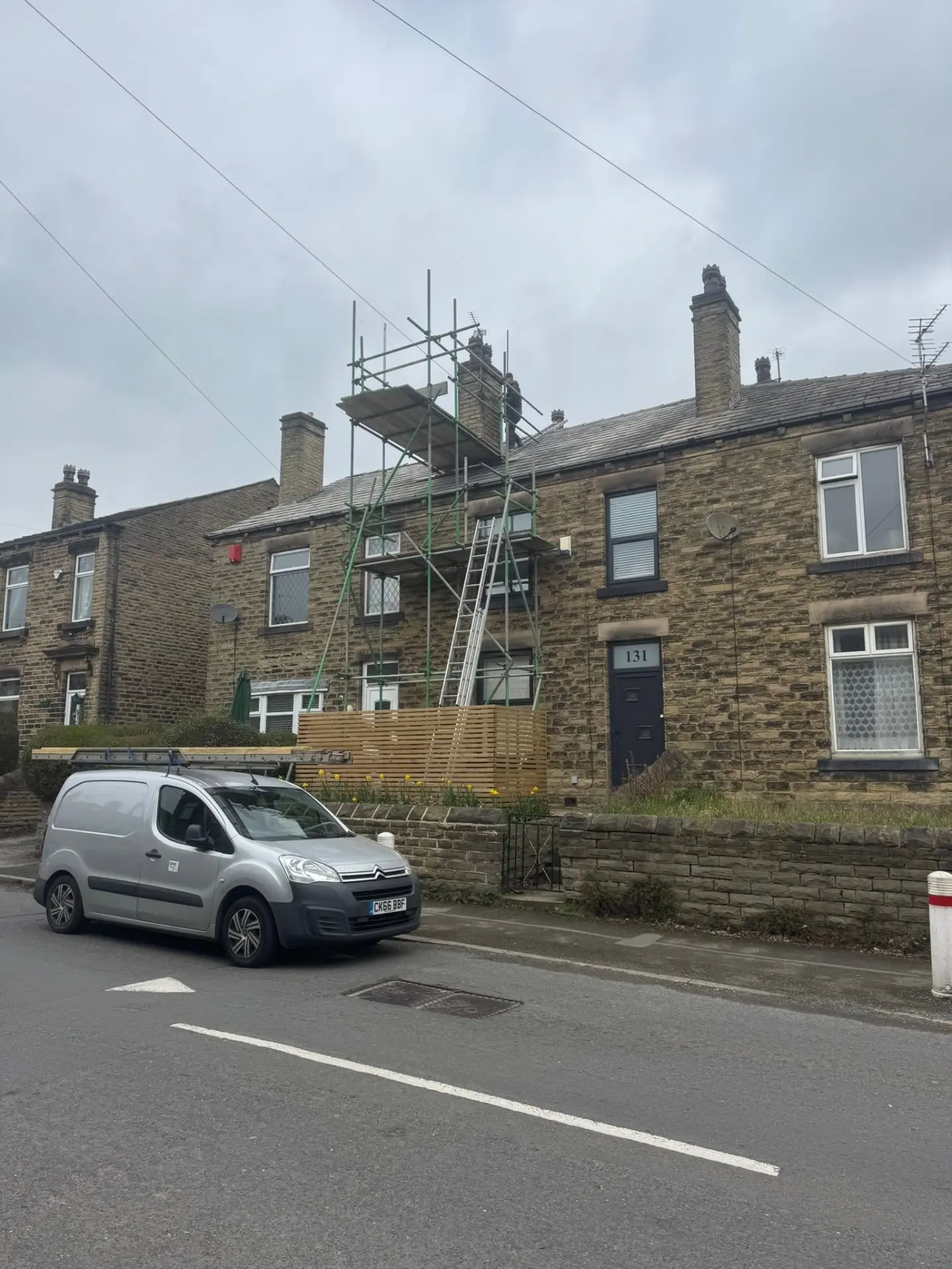Scaffolded stone terrace mid re-roof and chimney work