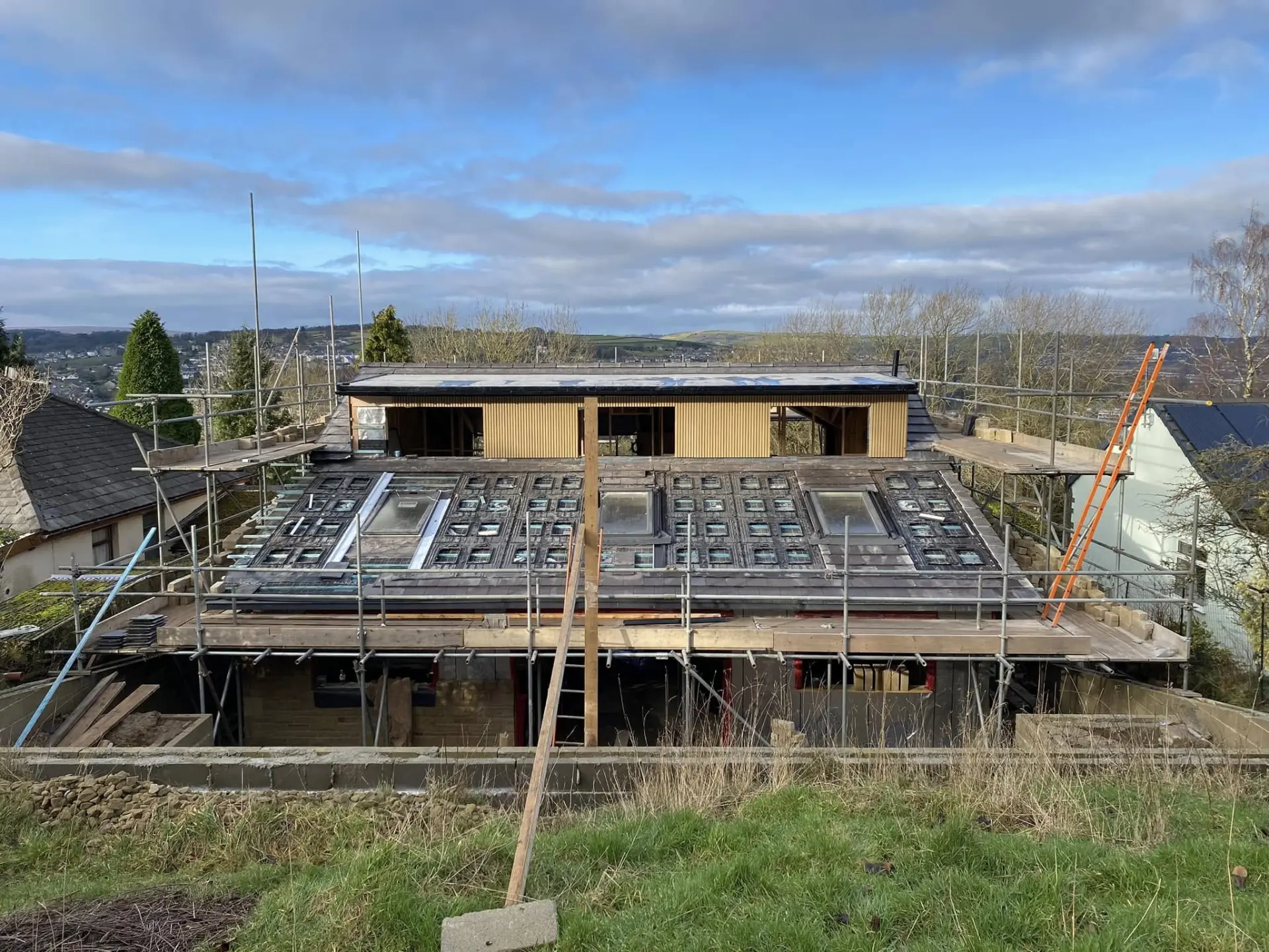 Fully scaffolded property mid re-roof with roof windows